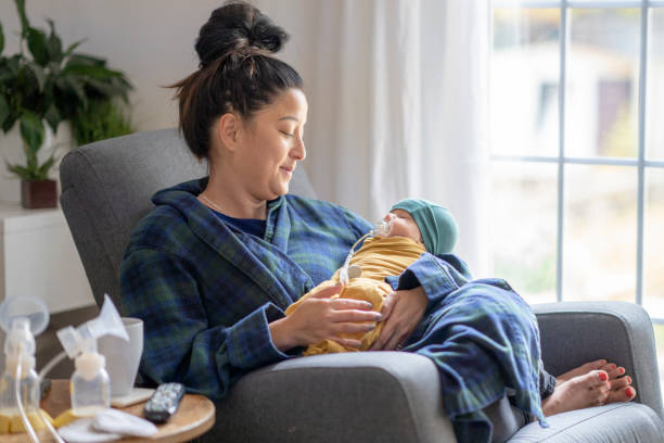 istock Tired new mother holding her baby 1282217912