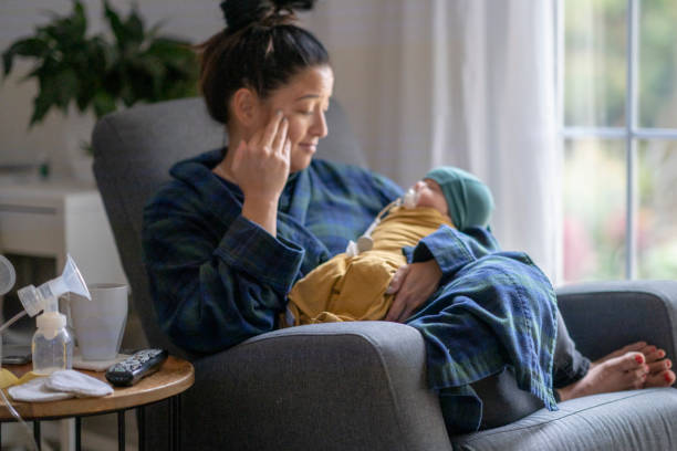 istock Tired new mother holding her baby 1282217923