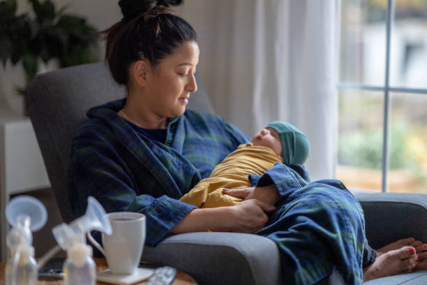 istock Tired new mother holding her baby 1282217929