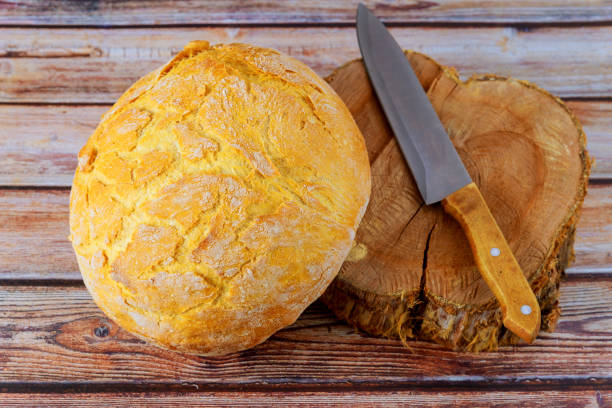 istock Freshly baked bread on wooden background. 1282221451