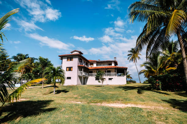 Caribbean themed cottages with back patios, white walkway. Small white country house for recreation. Caribbean themed cottages with back patios and white walkway. Small white country house for recreation. small florida home stock pictures, royalty-free photos & images