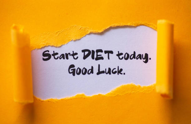 istock Text 'Start diet today. Good luck.' appearing behind torn paper. 1282226517