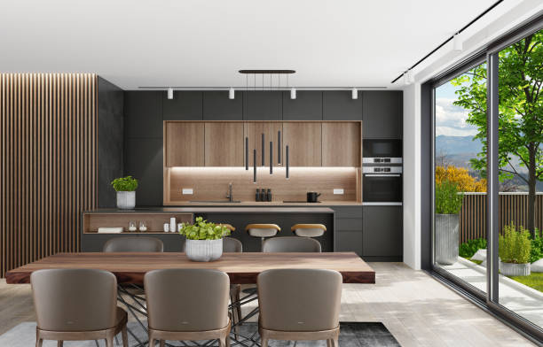 istock Country modern villa with garden. Matte black kitchen interior with island table and dining table. 1282227073