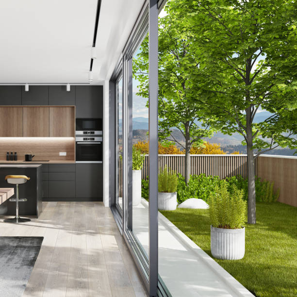 istock Country modern villa with garden. Matte black kitchen interior with island table and dining table. 1282227106