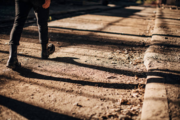 istock Male in combat boots walking in abandoned building 1282228293