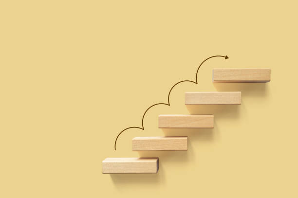 istock Growth or increase design concept. Cube block staircase moving step growing up to target. Success achievement or goal business motivation 1282228911