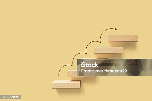 istock Growth or increase design concept. Cube block staircase moving step growing up to target. Success achievement or goal business motivation 1282228911