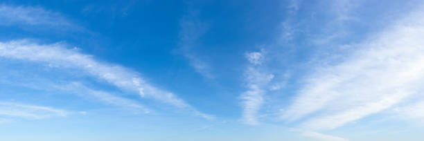 istock Translucent cirrus cloud stripes float slowly high in a bright blue sky on a sunny day. Panoramic skyscape shot. Weather, meteorology and types of clouds. 1282230204
