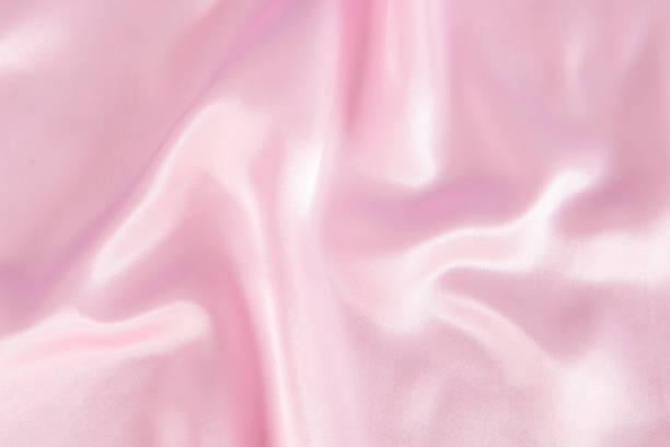 istock Abstract pink fabric texture background. Cloth soft wave. Creases of satin, silk 1282233400