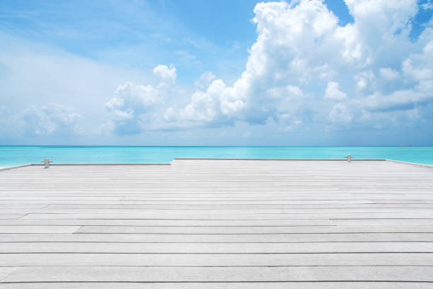 istock Wooden jetty with turquoise sea and clouds sky background 1282234452