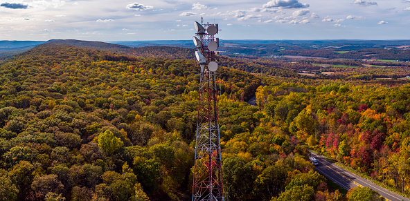 Telecommunication cell tower on a mountain ridge in the Appalachian Mountains, Poconos region, Pennsylvania, USA, in the fall.