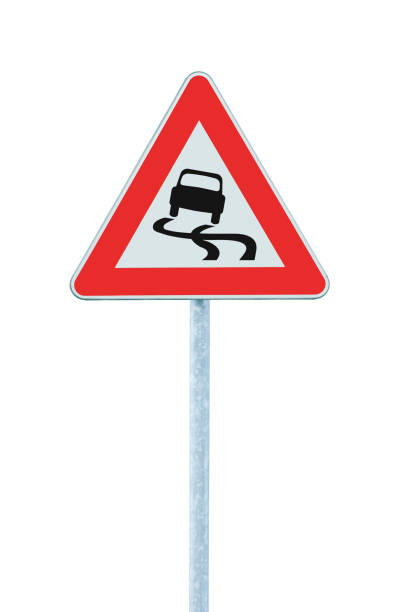 istock Slippery when wet road warning sign, isolated roadside signage pole post, vertical closeup 1282243590