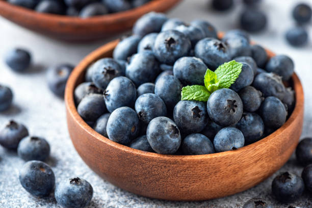 istock Blueberries in a wooden bowl 1282244328