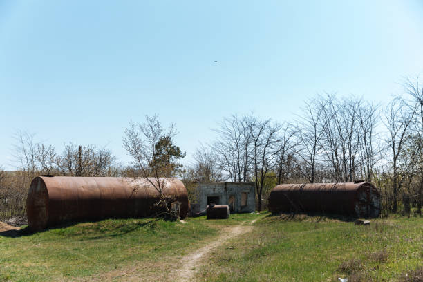 istock Two old abandoned rusty barrels lie in the open air on the grass 1282248344