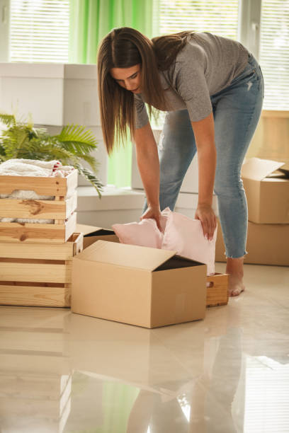 istock Young woman packing before moving into her new home 1282249164
