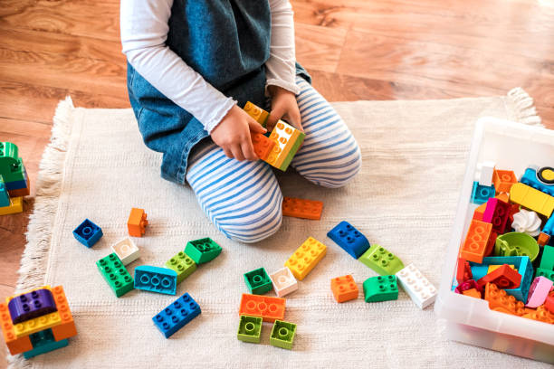 istock Little girl playing with her colorful blocks. 1282252750
