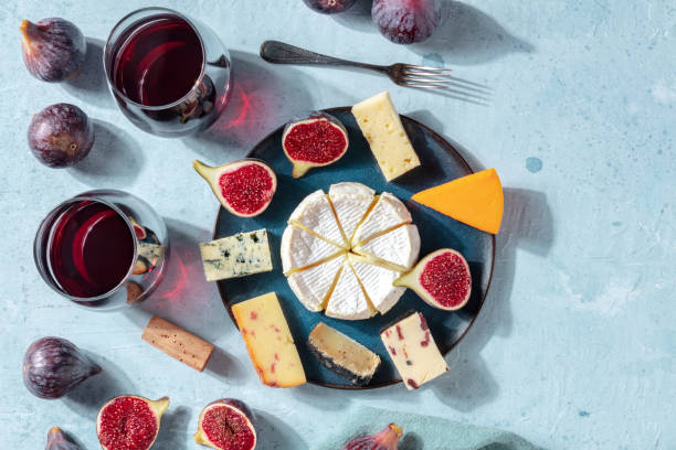 Cheese platter with wine and fruit, overhead photo with a place for text, a flatlay