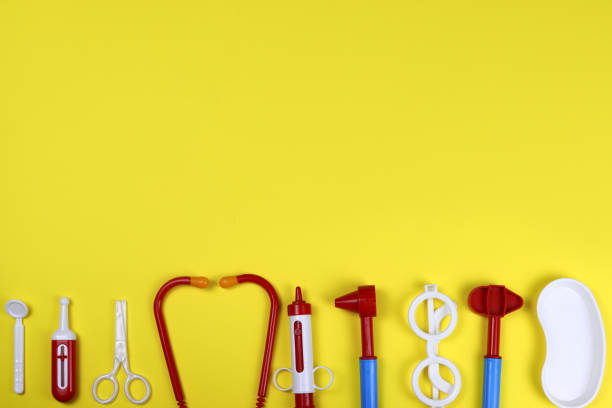 istock toy medical doctor's tools on a yellow background. Space for text 1282254752