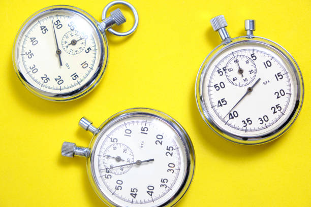 istock Three mechanical stopwatches on a yellow background. 1282256744