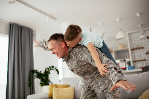istock Soldier having fun with his son at home. 1282257848