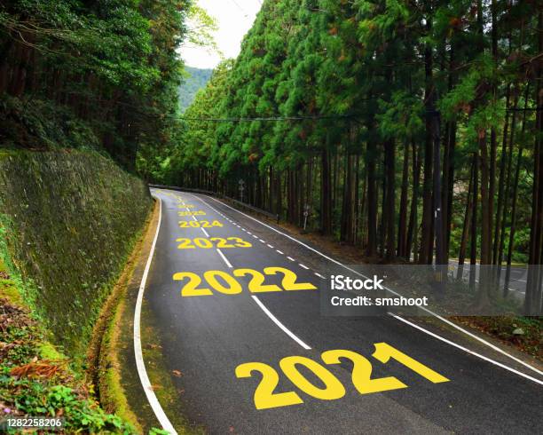 Ten Years From 2021 To 2030 On Highway Road And White Marking Lines In The Forest Stock Photo - Download Image Now