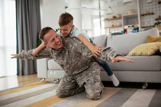 istock Soldier having fun with his son at home. 1282258294