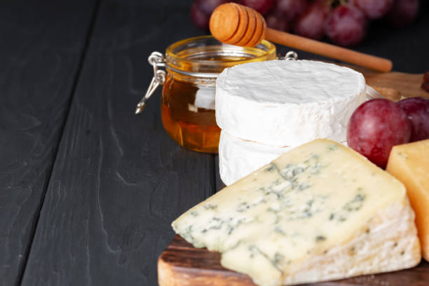 istock Cheese served with grapes and honey on grey surface 1282258647