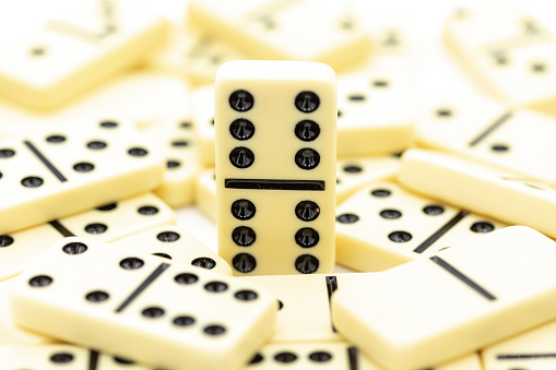 Success concept of dominoes standing out from the crowd