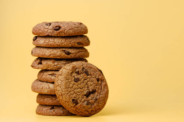 istock Pile of chocolate chip cookies on yellow backgreound 1282259661