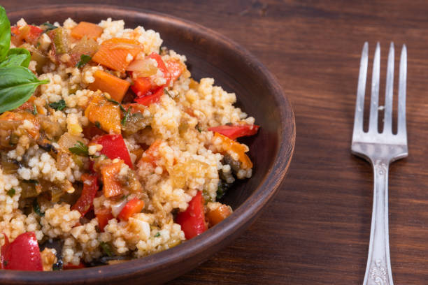 istock Couscous with stewed vegetables is a Moroccan, Algerian and Tunisian dish. Couscous mixed with stewed vegetables in a traditional clay plate 1282259957