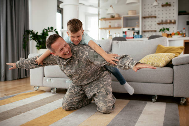 istock Soldier having fun with his son at home. 1282260542