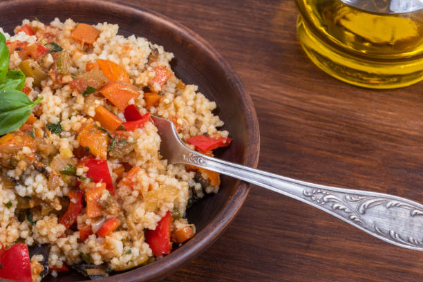 istock Couscous with stewed vegetables is a Moroccan, Algerian and Tunisian dish. Couscous mixed with stewed vegetables in a traditional clay plate 1282260613