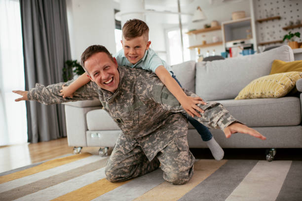 istock Soldier having fun with his son at home. 1282260659