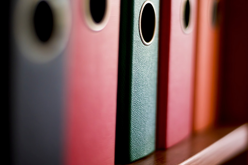 Colorful folders to keep documents in an office. Macrophotography of a folder.