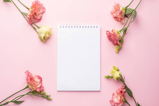 istock Notebook and pink flower bouquet on pastel background 1282262192