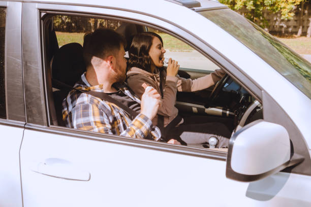 istock couple having chocolate snack while riding in car 1282263404