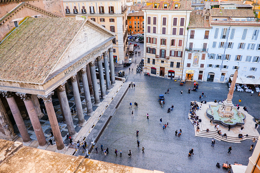 Rome, Italy, October 22 -- A view from the rooftops of the iconic Piazza della Rotonda quarter, in the heart of Rome. At left the famous Pantheon colonnade, one of the best preserved Roman structures in the Eternal City. The Pantheon was built in 27 b.C. by the Consul Marco Vispanio Agrippa for the emperor Augustus and dedicated to all Roman gods. Currently the Pantheon it is home to a Catholic church and inside there are the tombs of some Italian kings and the remains of the great Renaissance artist Raffaello Sanzio (Raphael). The fountain in the center of the square with an original Egyptian obelisk was built by the sculptor Leonardo Sormani in 1575 to a design by the architect Giacomo della Porta. Image in High Definition Format.