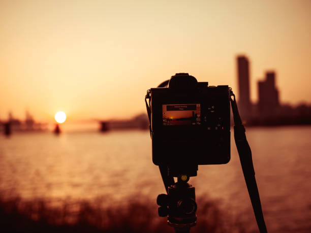 istock Close-Up Of Camera Against Sky During Sunset And Bridge 1282265296