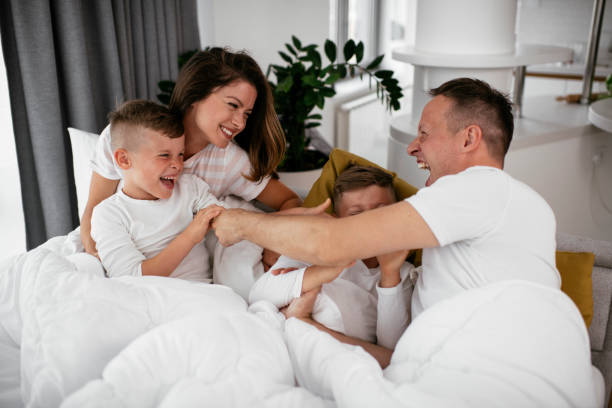 istock Happy parents with sons relaxing in bed 1282265298