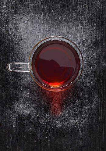 Looking down on a tea glass on dark wooden background