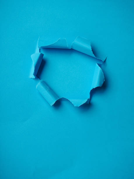 istock Ripped Paper Hole with blue coloured background 1282266647