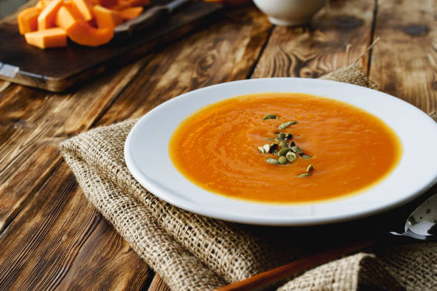 istock Creamy pumpkin soup on a wooden table 1282268944