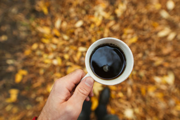 istock POV, man holding cup with coffee 1282270236