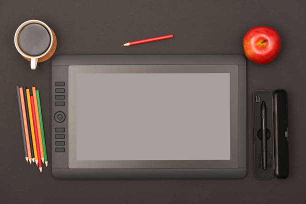 Graphic monitor stylus and glove on black color table. Black tablet computer with blank screen. High resolution photo. Full depth of field. Working environment concept