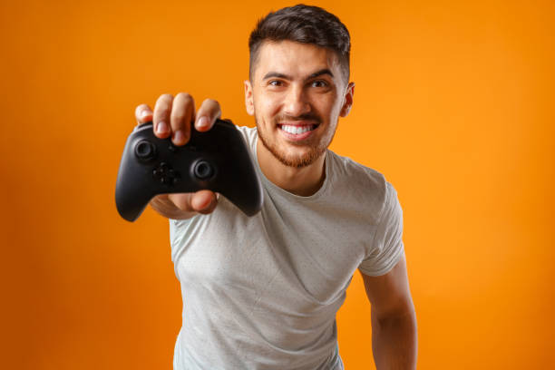 istock Handsome mixed-race man holding video games joystick 1282271445