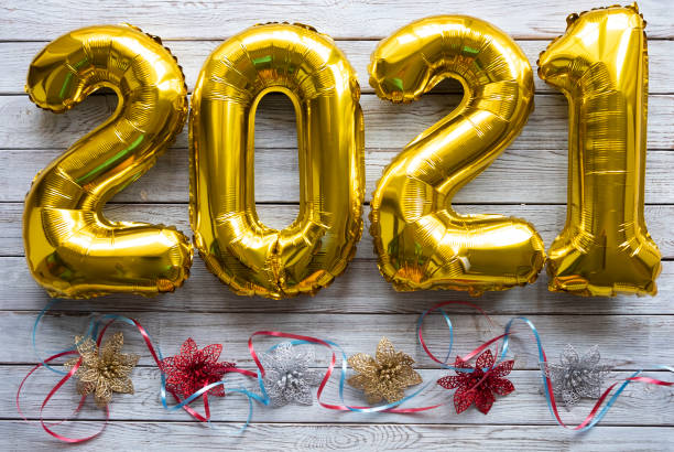 istock A rustic gray wood background with 2021 in inflatable golden numbers 1282273108