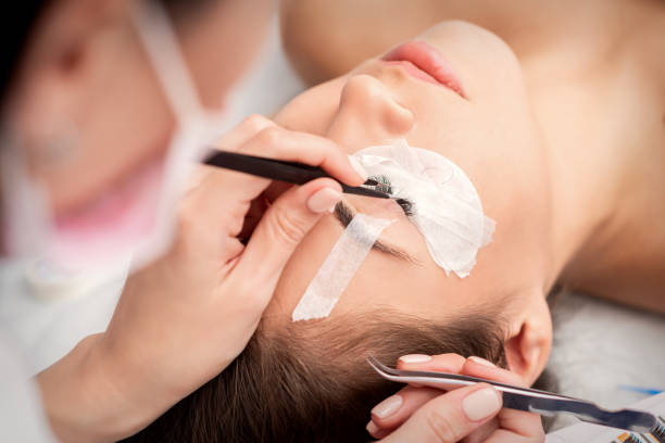 istock Woman receiving eyelash extensions procedure 1282273165