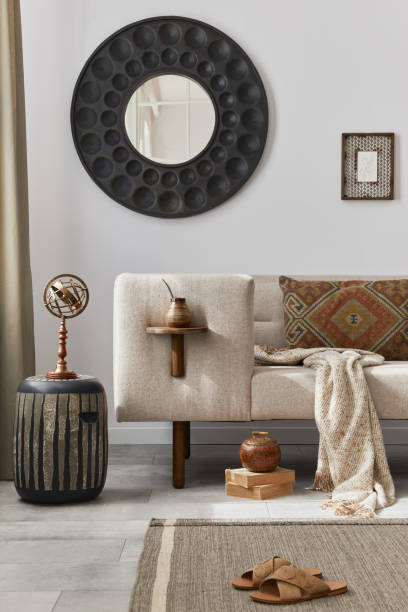 istock Elegant ethnic composition of living room interior with design coffee table, sofa, decoration , mock up frame and acceessories in modern home decor. Template. Details. 1282274100