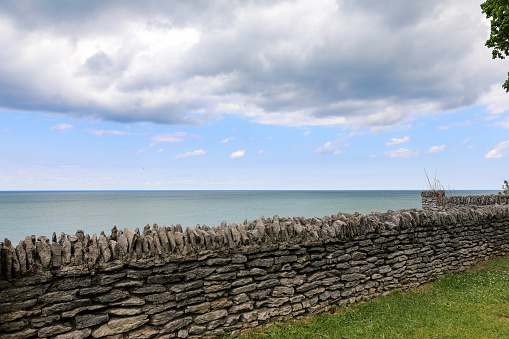 Stone wall above Olcott beach. Storm cloud over the water on Lake Ontario