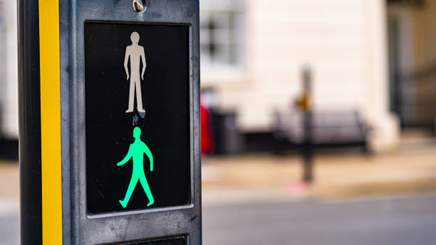istock A pedestrian crossing sign with green man illuminated 1282276673